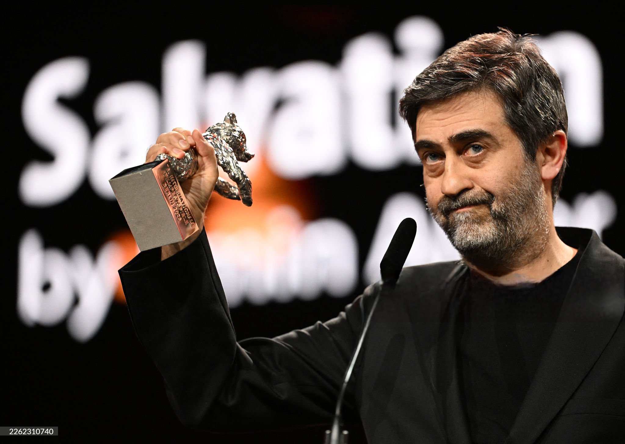 Turkish film director Emin Alper accepts the Silver Bear Grand Jury Prize for his film "Kurtulus" (Salvation) during the Award Ceremony of the 76th Berlinale, Europe's first major film festival of the year, in Berlin on February 21, 2026. The 76th Berlin Film Festival draws to a close after 10 days, with 22 films in competition. (Photo by RALF HIRSCHBERGER / AFP via Getty Images)